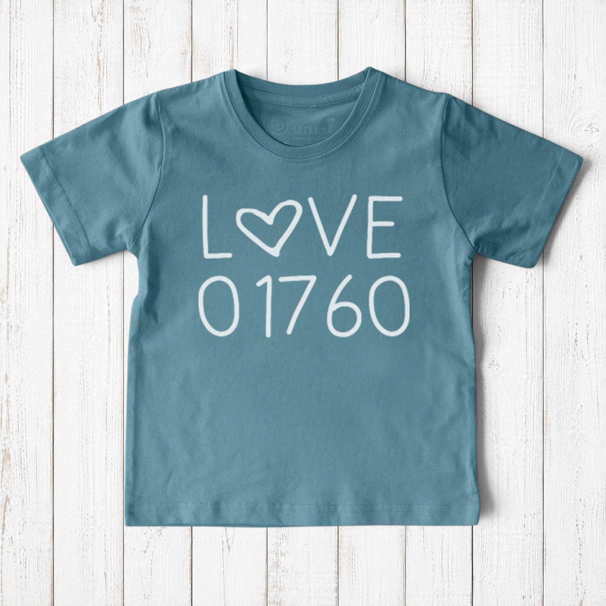 Uni-T kids blue organic cotton t-shirt featuring a white hand-drawn Love 01760 graphic for Natick pride