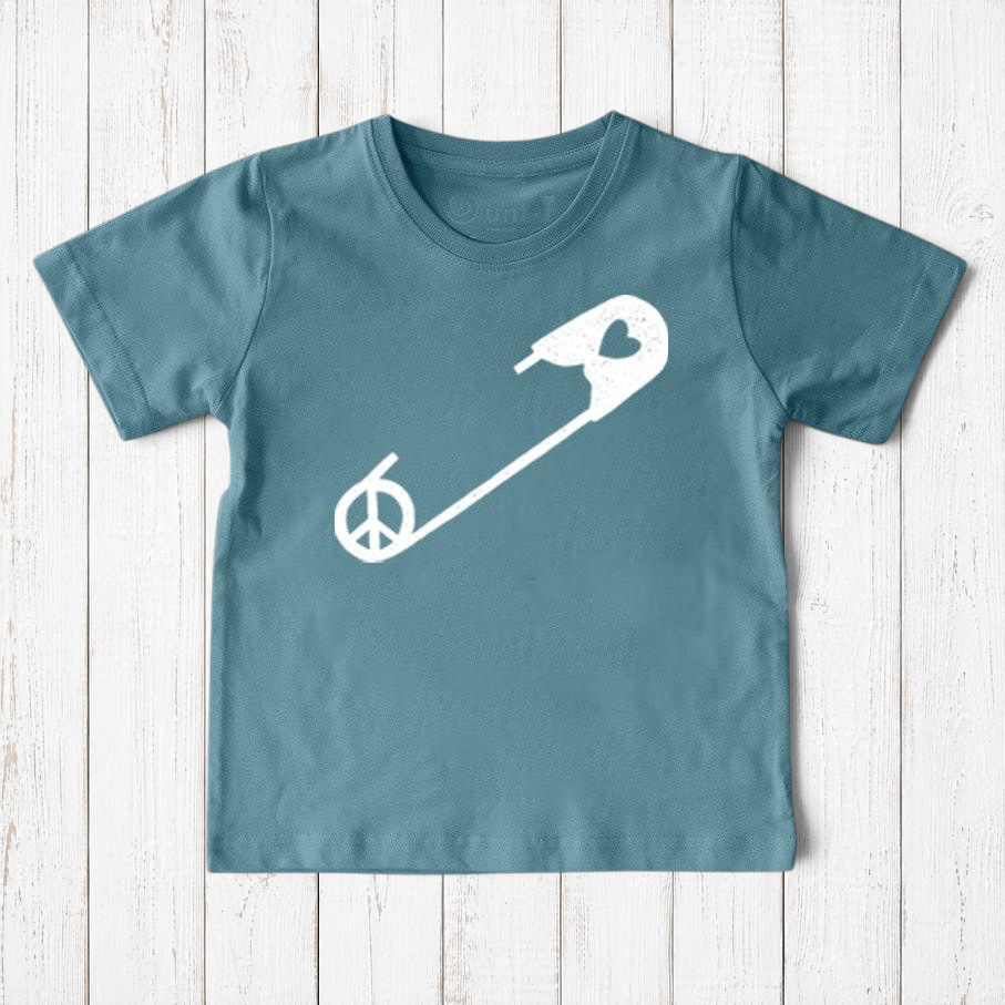 Uni-T kids organic cotton t-shirt in blue featuring a white safety pin graphic with a peace sign and heart detail.