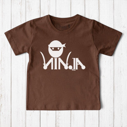 Uni-T brown organic cotton kids t-shirt featuring a white ninja graphic and text on a rustic wooden background