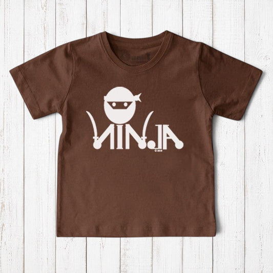 Uni-T brown organic cotton kids t-shirt featuring a white ninja graphic and text on a rustic wooden background
