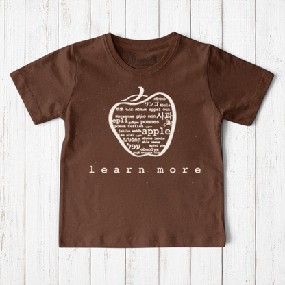 Uni-T brown organic cotton kids t-shirt featuring a white hand-illustrated apple graphic with multilingual text.