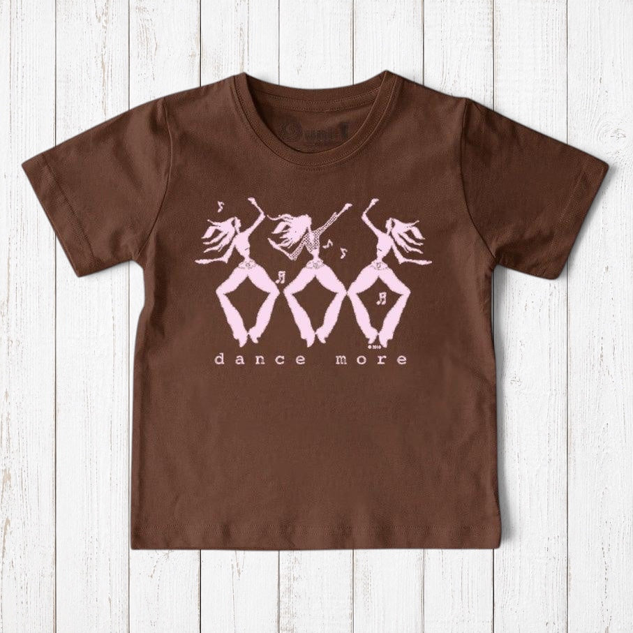 Uni-T organic cotton brown kids t-shirt featuring a pink hand-illustrated Dance More graphic on a wooden background