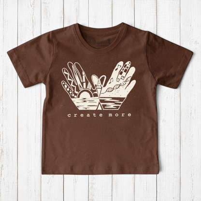 Uni-T kids brown organic cotton t-shirt featuring a white hand-drawn Create More artistic graphic print