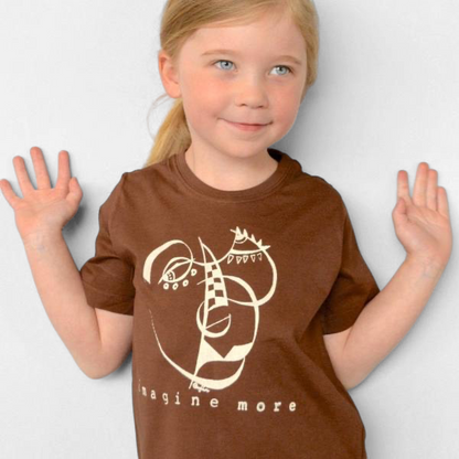 Young girl wearing a brown Uni-T organic cotton t-shirt with a white hand-drawn Imagine More artistic graphic print.