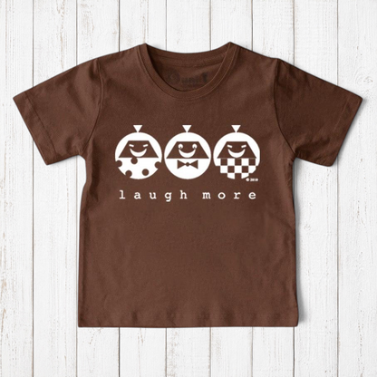 Uni-T brown organic cotton kids t-shirt featuring a white Laugh More graphic with three playful illustrated faces.