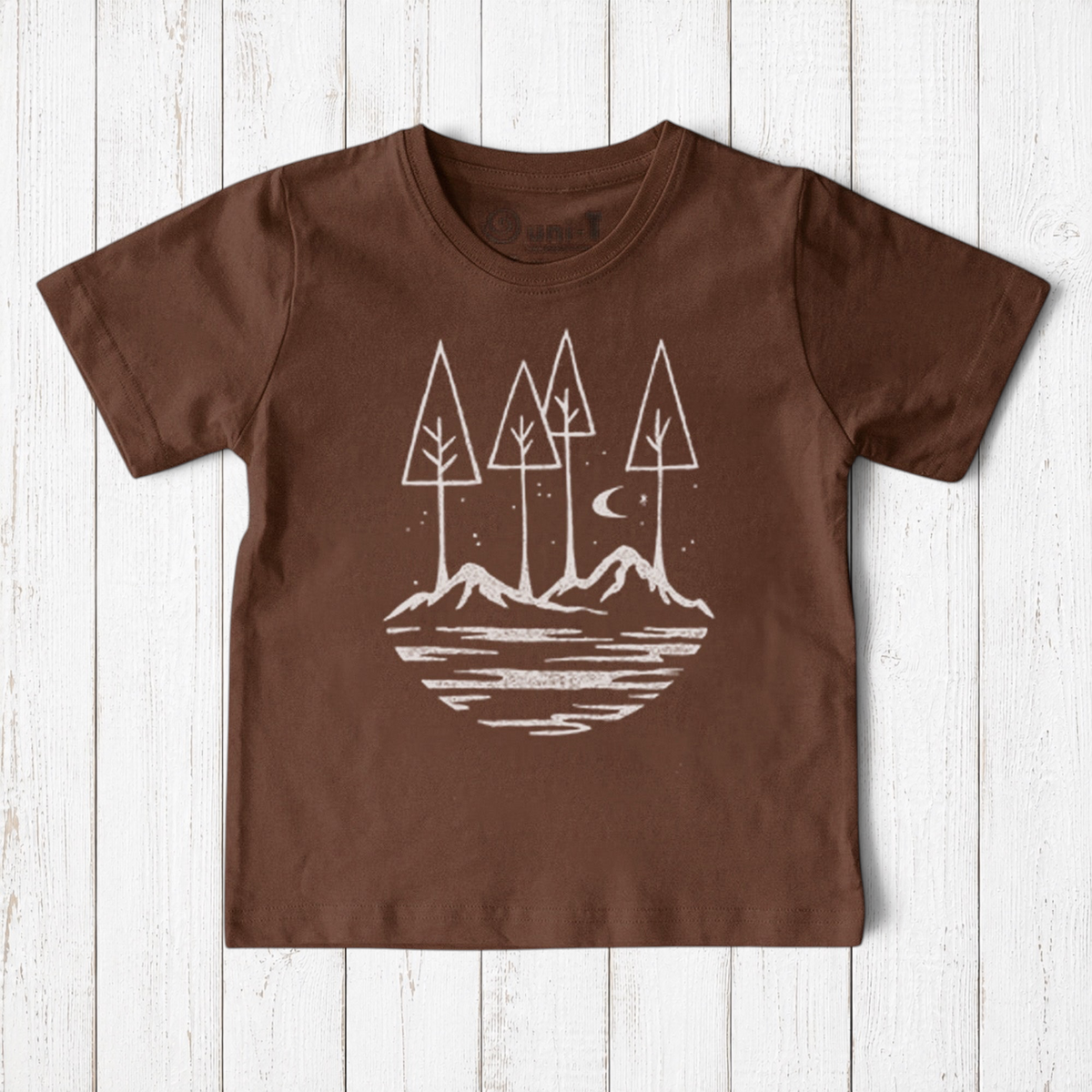 Uni-T kids brown organic cotton t-shirt featuring a white hand-drawn nature graphic of trees, mountains, and moon.