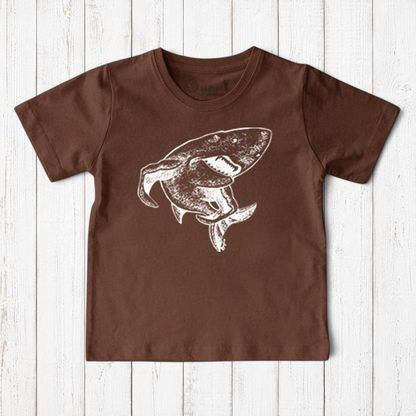 Uni-T kids brown organic cotton t-shirt featuring a white hand-illustrated shark graphic from a children's book.