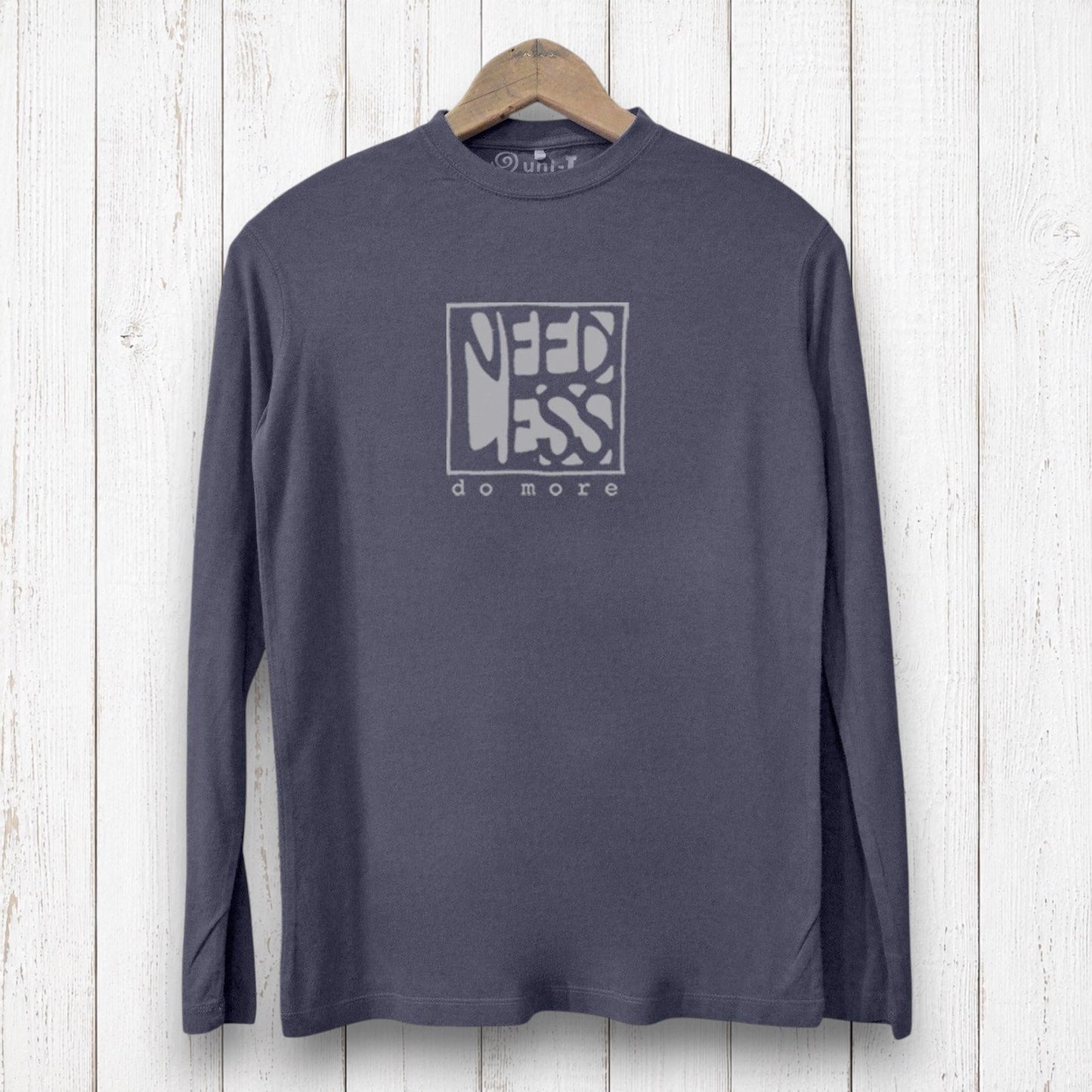 Uni-T charcoal grey long sleeve bamboo and organic cotton graphic tee with Need Less Do More print on a wooden hanger