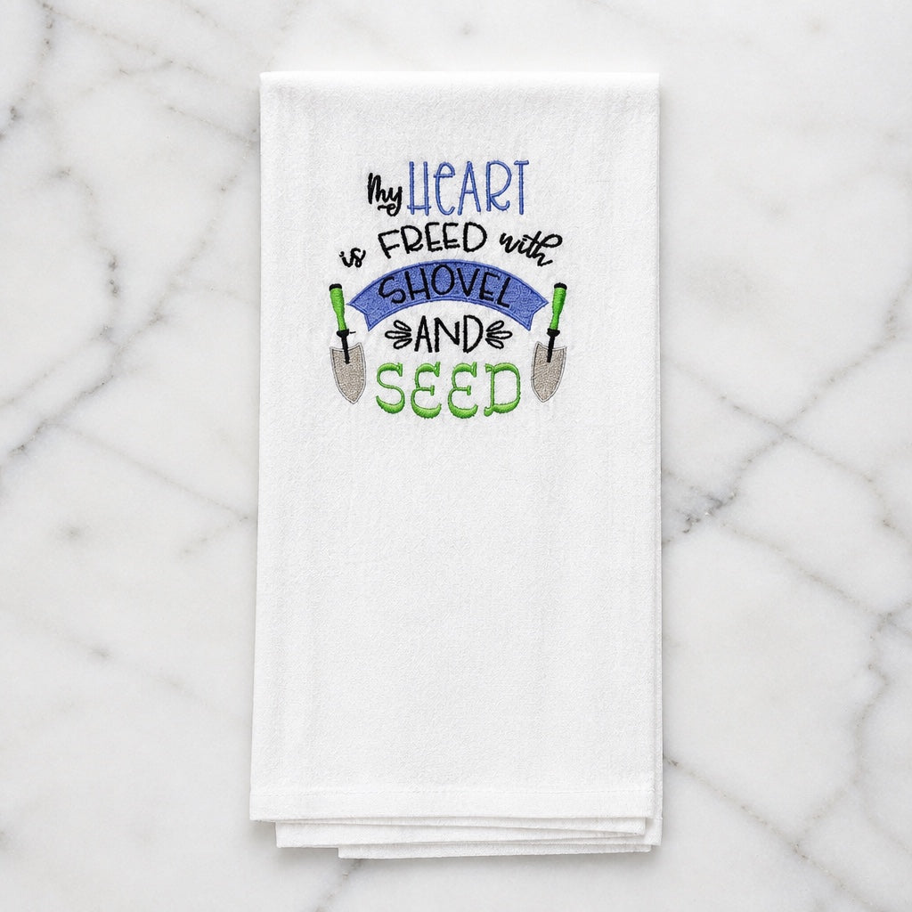 Uni-T white bamboo kitchen towel with My heart is freed with shovel and seed embroidery for gardeners.