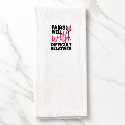 Uni-T white flour sack kitchen towel with black and pink embroidered text Pairs Well With Difficult Relatives
