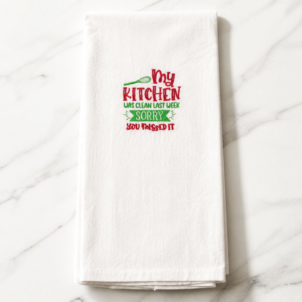 Uni-T white flour sack kitchen towel with red and green embroidered text My kitchen was clean last week sorry you missed it