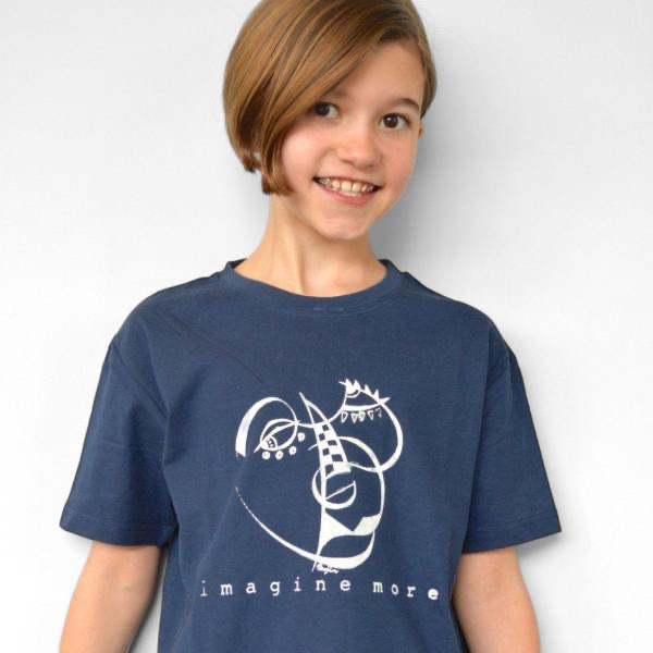 A young girl wearing a navy blue Uni-T organic cotton t-shirt featuring a white hand-drawn Imagine More graphic.