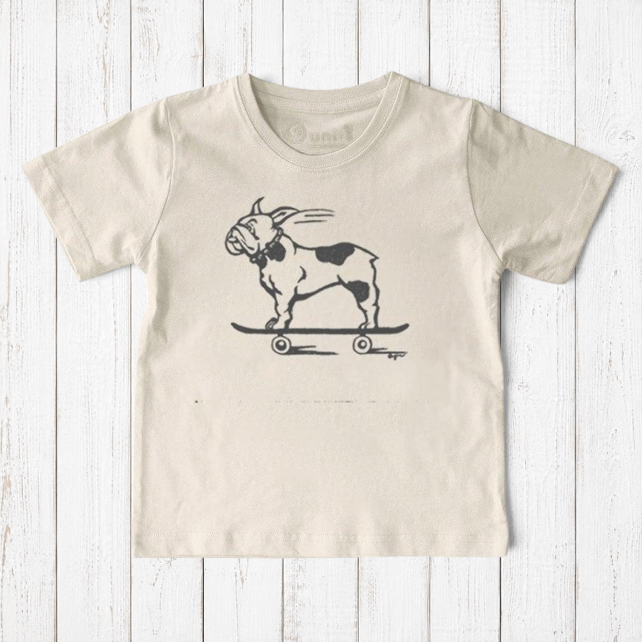 Uni-T kids organic cotton t-shirt in cream featuring a hand-illustrated black French Bulldog riding a skateboard.