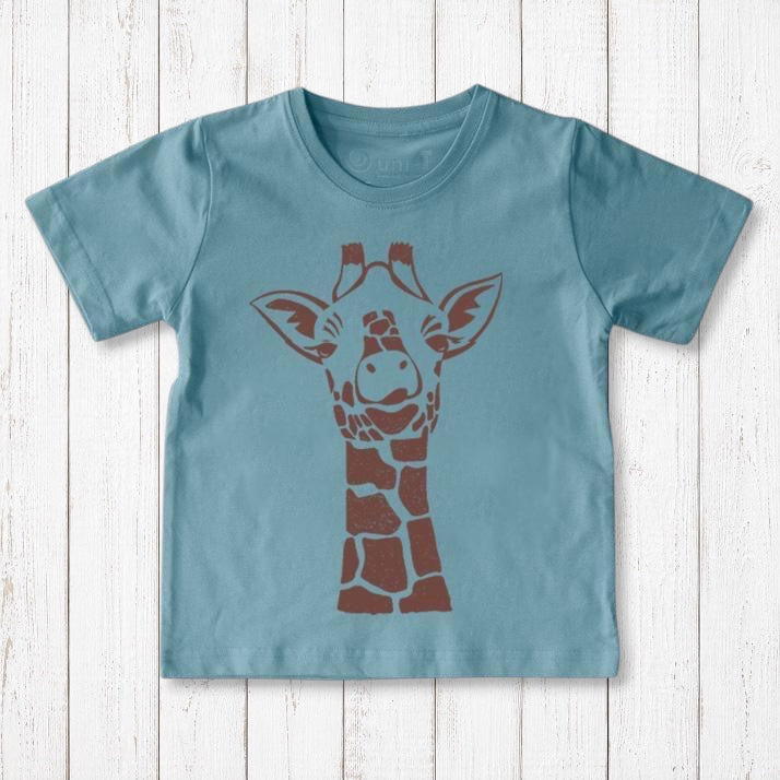 Uni-T kids organic cotton t-shirt in dusty blue with a brown giraffe graphic illustration on a white wood background