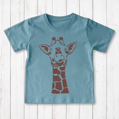 Uni-T kids organic cotton t-shirt in dusty blue with a brown giraffe graphic illustration on a white wood background