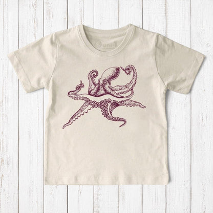 Uni-T kids organic cotton t-shirt in cream featuring a hand-illustrated purple octopus graphic on a wooden background