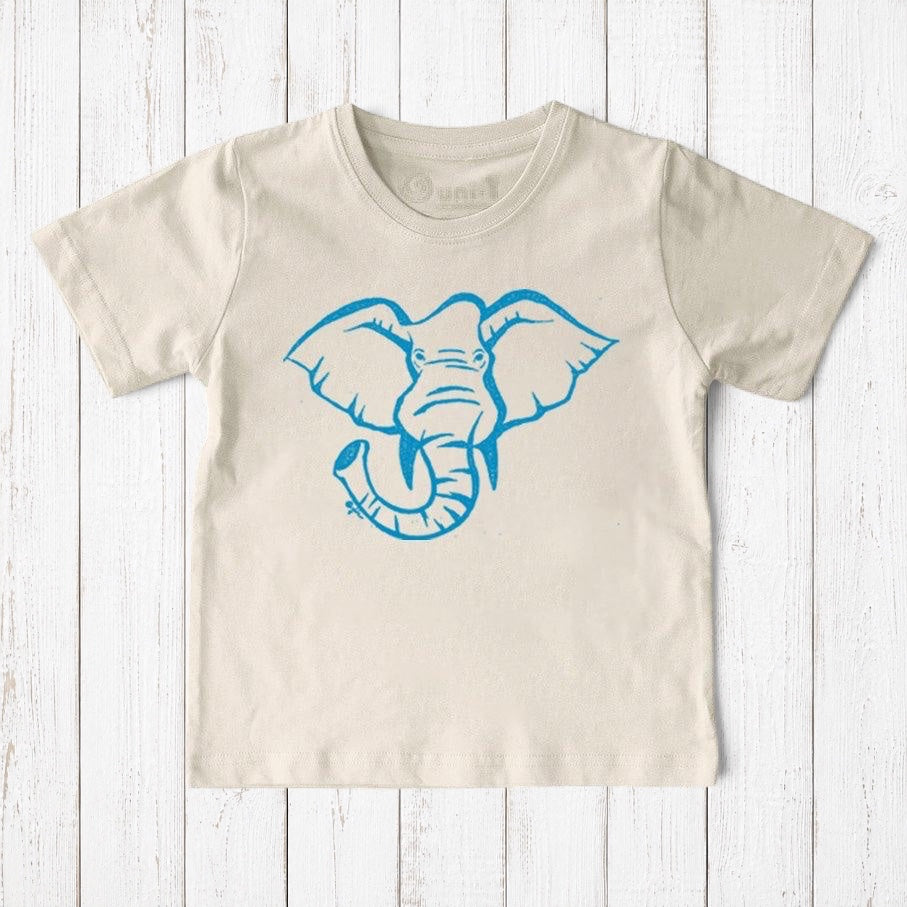 Uni-T kids organic cotton t-shirt in beige featuring a blue hand-illustrated elephant graphic on a white wood background