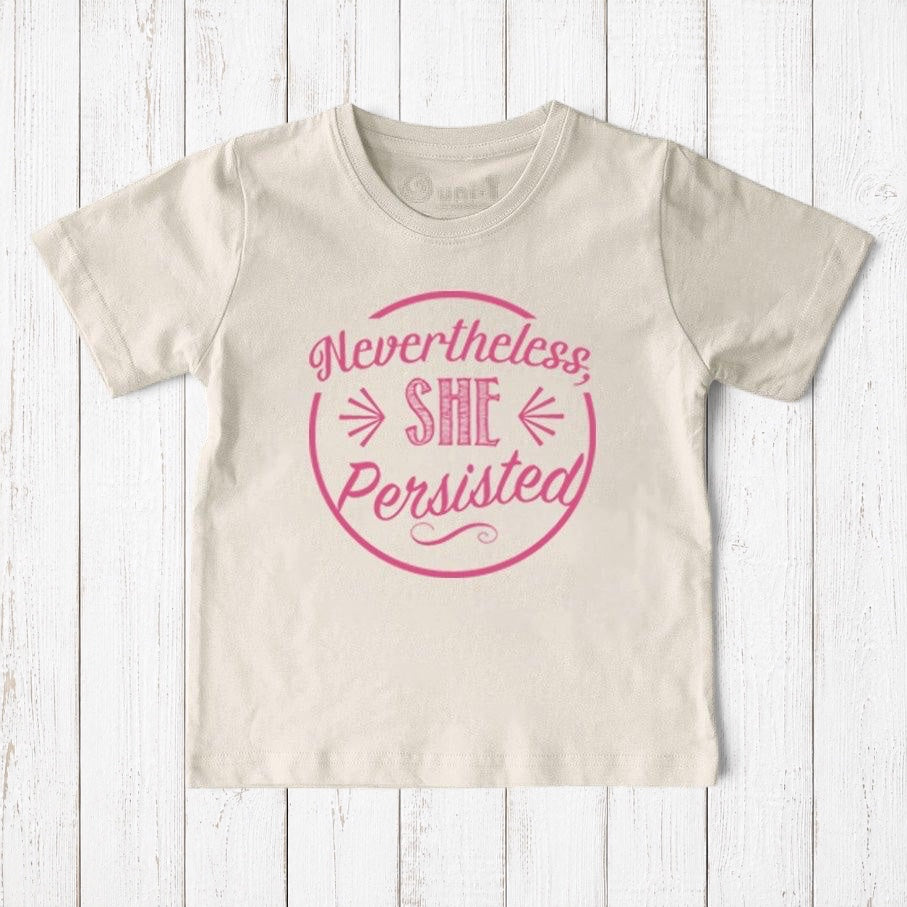 Uni-T kids organic cotton t-shirt in cream with pink Nevertheless She Persisted graphic print on rustic wood background