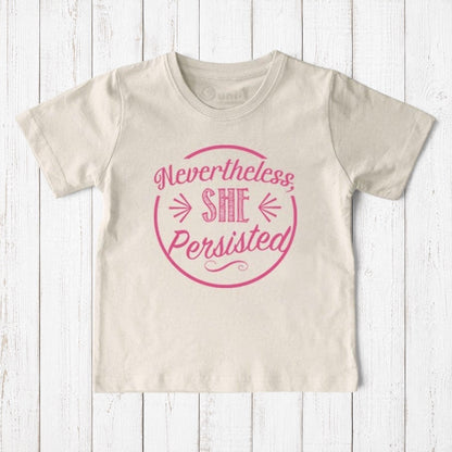 Uni-T kids organic cotton t-shirt in cream with pink Nevertheless She Persisted graphic print on rustic wood background
