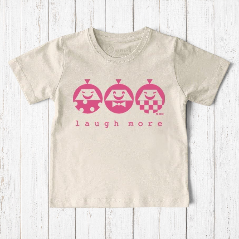Uni-T kids organic cotton t-shirt in cream with a pink Laugh More graphic featuring three playful illustrated faces.
