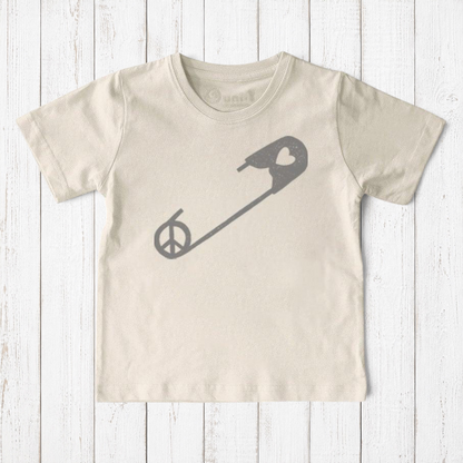 Uni-T kids organic cotton t-shirt in cream with a grey safety pin graphic featuring a peace sign symbol