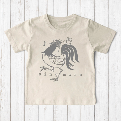 Uni-T kids organic cotton t-shirt in cream featuring a hand-illustrated grey rooster graphic with musical notes.