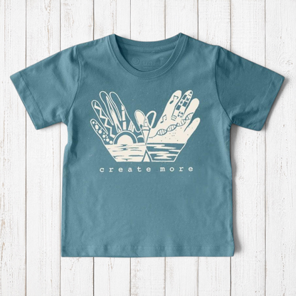Uni-T kids organic cotton t-shirt in teal with a white hand-drawn Create More graphic illustration