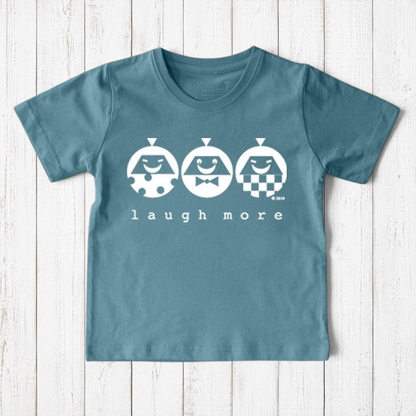 Uni-T kids organic cotton t-shirt in blue with a white Laugh More graphic featuring three playful illustrated faces.