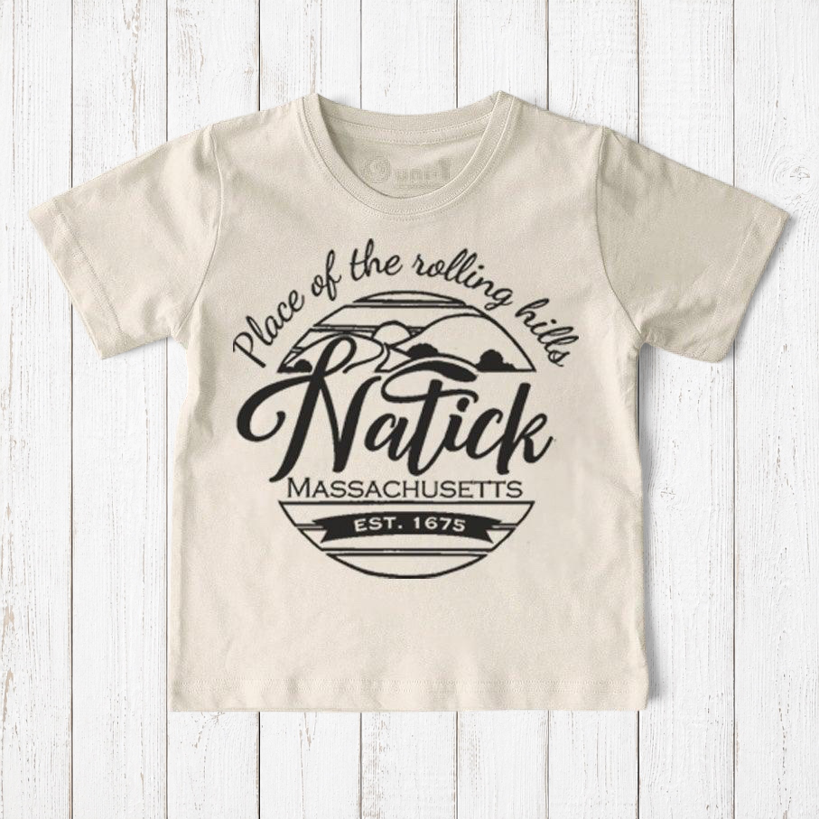 Uni-T kids organic cotton t-shirt in cream featuring a black Natick Massachusetts circle logo graphic design