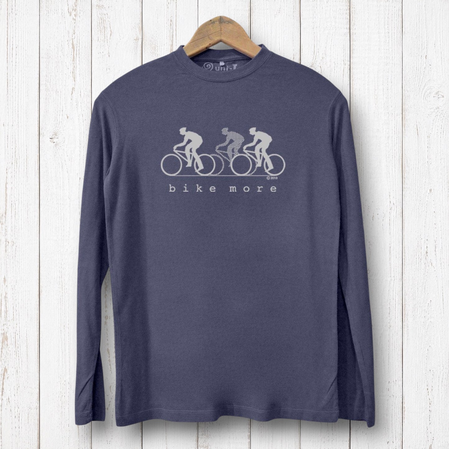 Uni-T men's navy bamboo long sleeve t-shirt with white Bike More graphic print on a rustic white wood background.