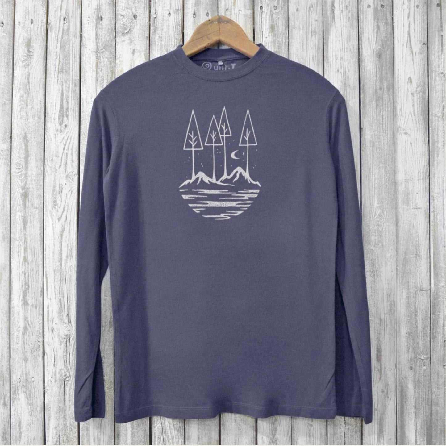 Uni-T navy blue long sleeve bamboo t-shirt featuring a white hand-printed mountain and forest graphic on a hanger.