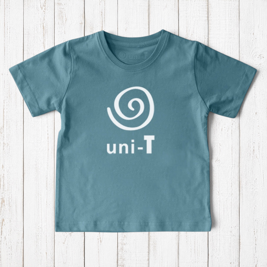 Uni-T kids organic cotton t-shirt in dusty blue with a white spiral unity graphic logo on a rustic wood background