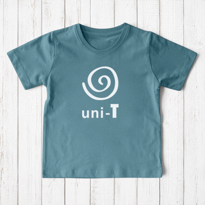 Uni-T kids organic cotton t-shirt in dusty blue with a white spiral unity graphic logo on a rustic wood background
