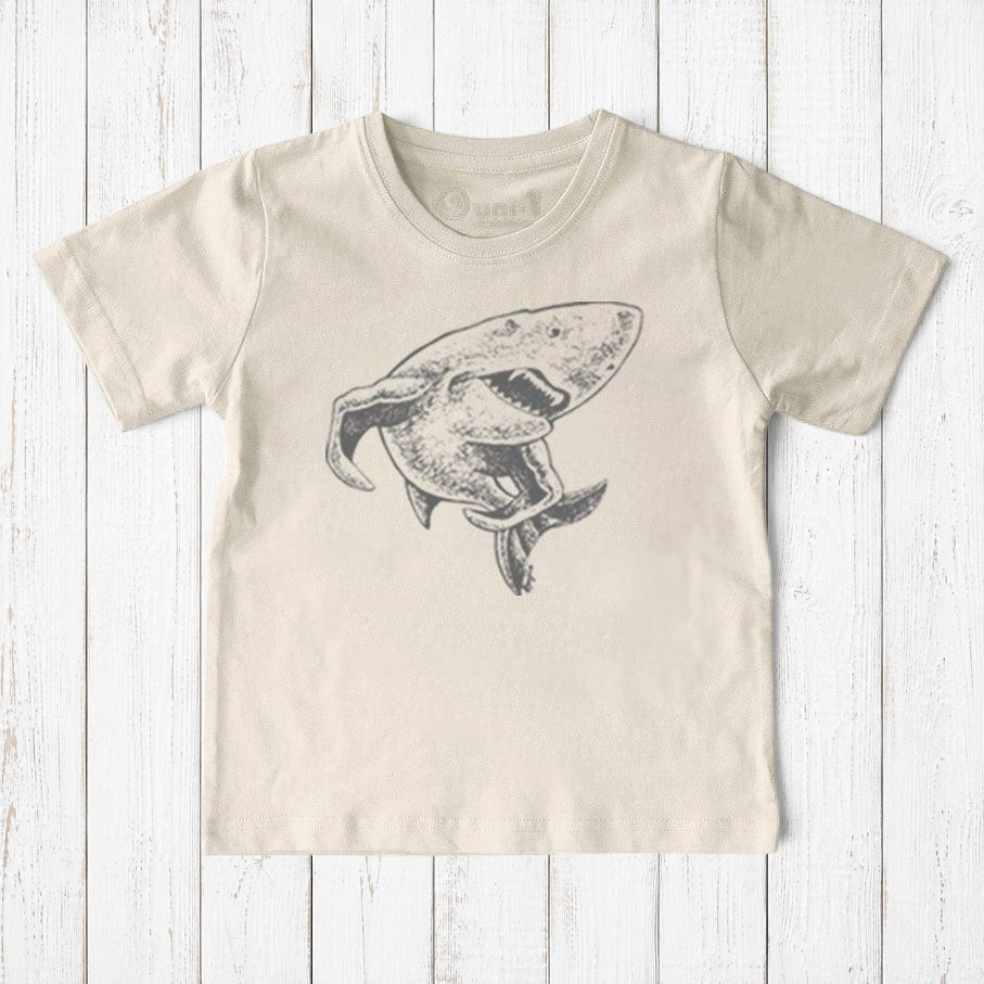Uni-T kids organic cotton t-shirt in cream with a hand-illustrated grey shark graphic from a children's book.