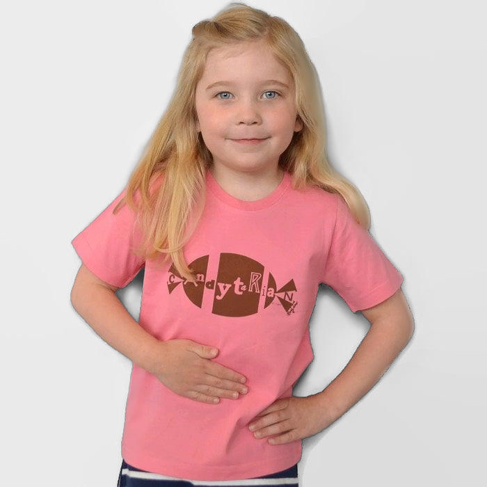Young girl wearing a pink Uni-T organic cotton t-shirt with a brown Candytarian candy graphic print