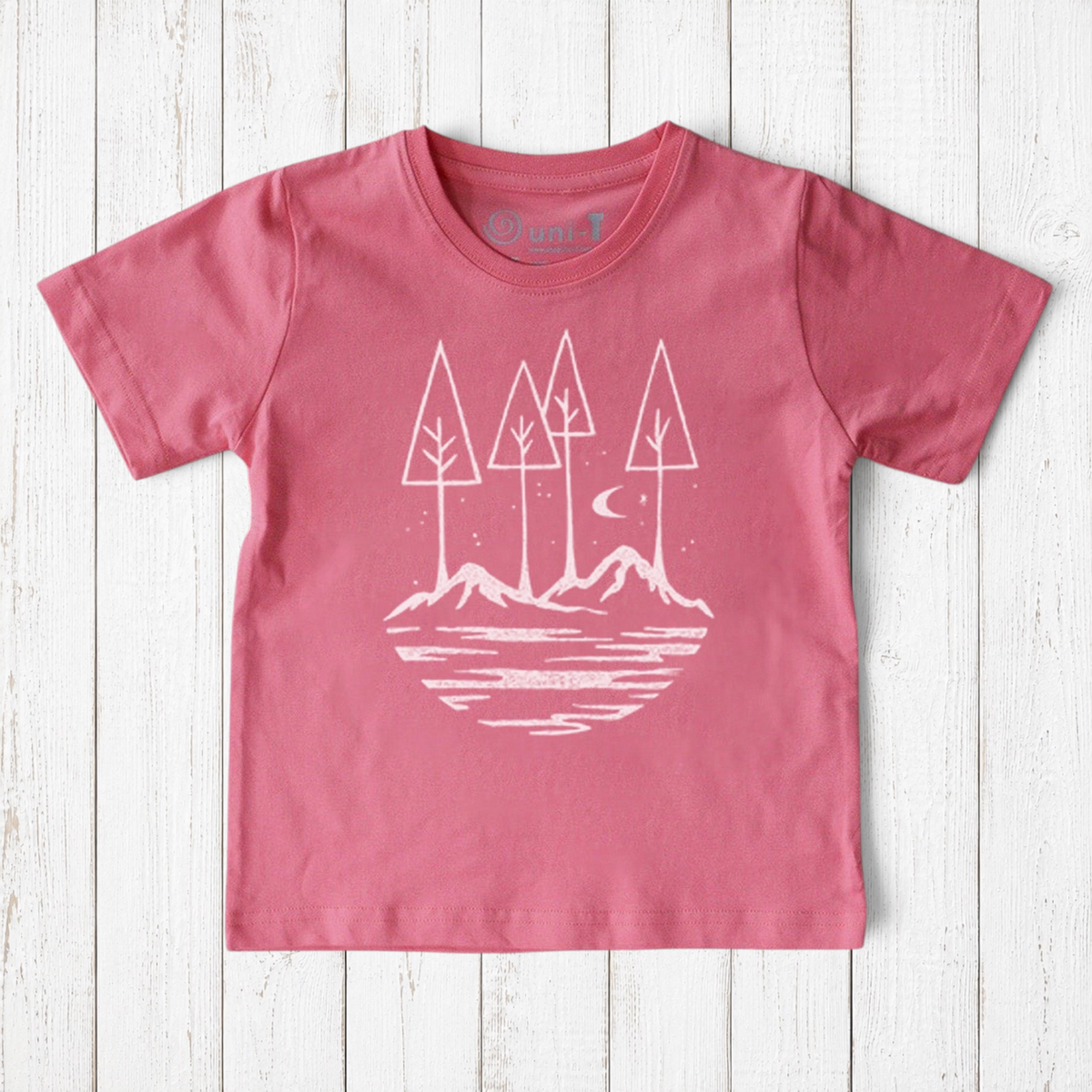 Uni-T kids organic cotton t-shirt in dusty pink with white hand-illustrated nature graphic of trees, moon, and river.