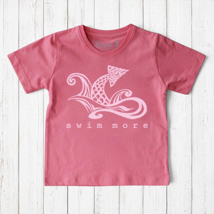 Uni-T kids organic cotton t-shirt in dusty pink with a white hand-drawn fish tail graphic and Swim More text.