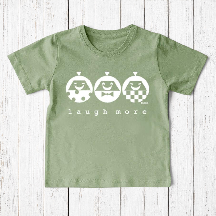 Uni-T kids sage green organic cotton t-shirt featuring a white Laugh More graphic with three playful illustrated faces.