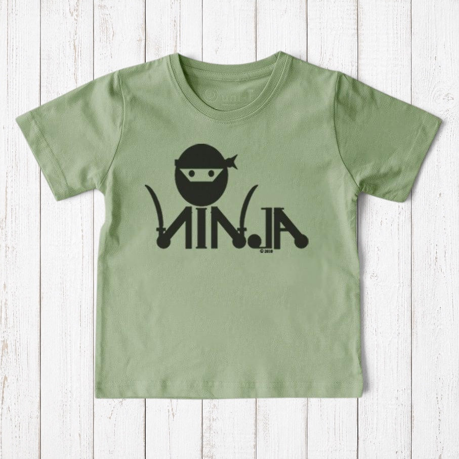 Uni-T sage green organic cotton kids t-shirt with black ninja graphic print on a rustic white wooden background