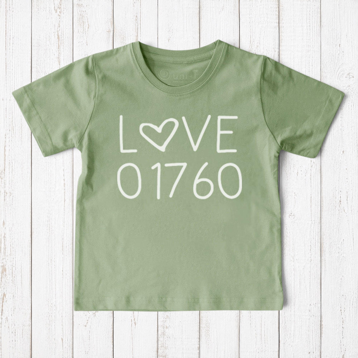 Uni-T sage green organic cotton kids t-shirt featuring a white Love 01760 Natick graphic print