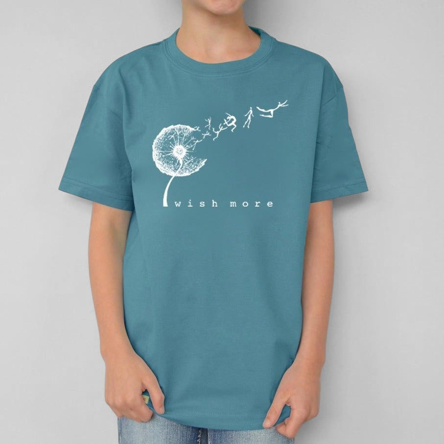 Child wearing a Uni-T teal organic cotton t-shirt featuring a white hand-drawn dandelion graphic and Wish More text