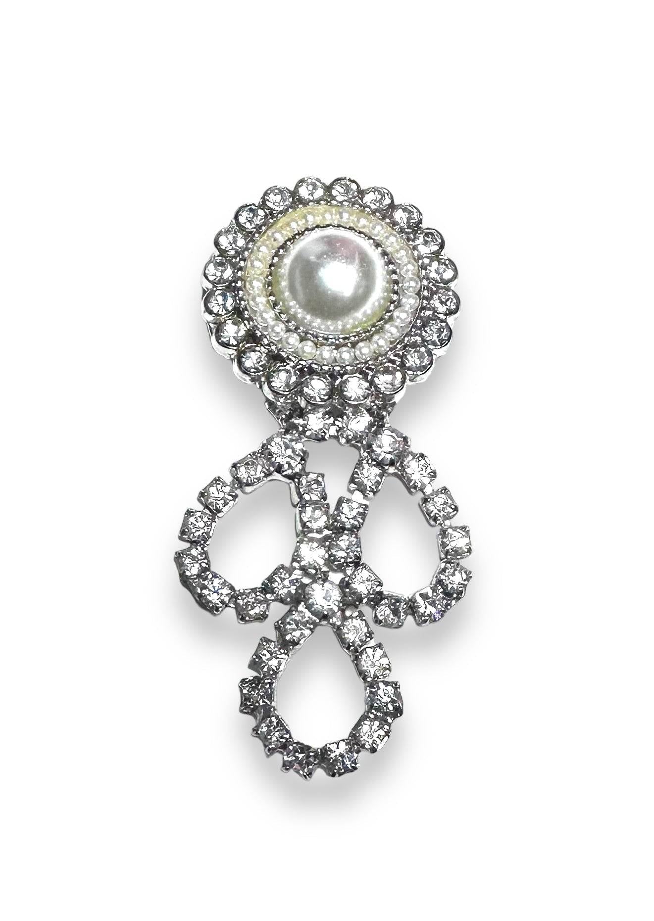 Elegant Uni-T magnet brooch with pearl center and rhinestone loops, perfect for accessorizing scarves or as a unique small gift.