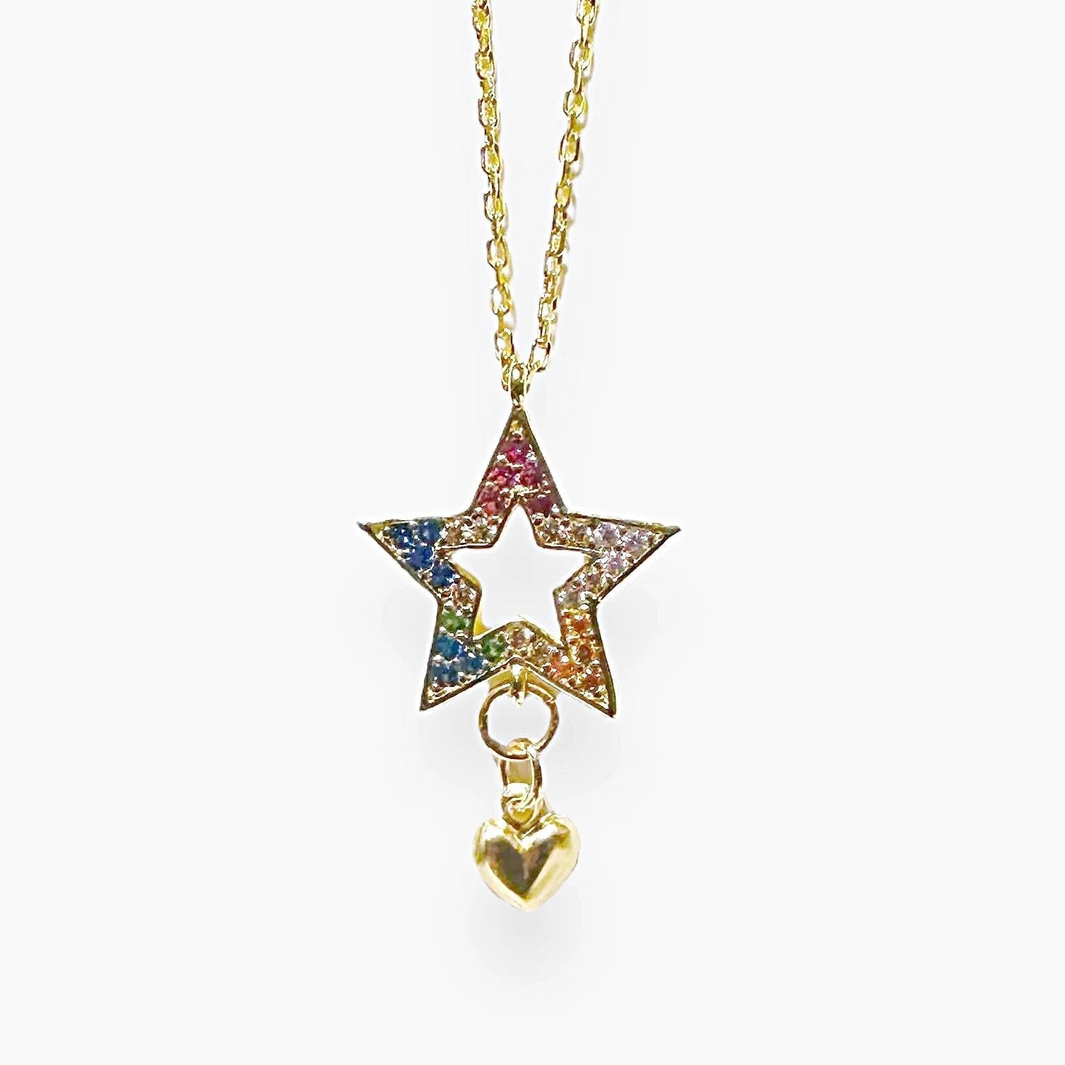 Front view of Cubic Zirconia Star Necklace on gold chain, showcasing rainbow-colored stones and a gold heart charm for versatile styling.