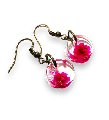 Round resin earrings with bright magenta flowers and bronze hooks. Unique design from Pressed Flower Earrings - Real Flowers.