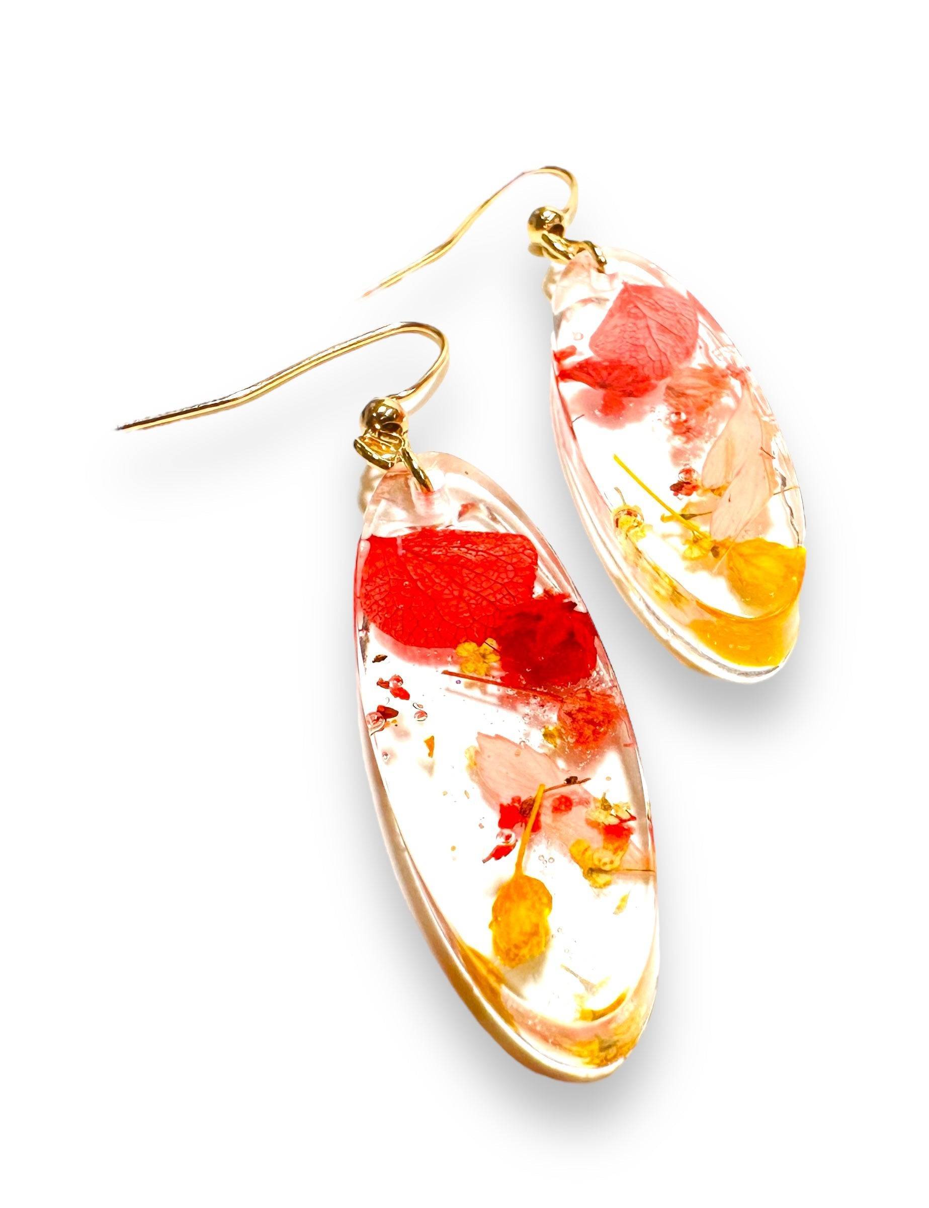 Oval resin earrings with red and yellow real flowers and gold hooks. From the Pressed Flower Earrings - Real Flowers line.