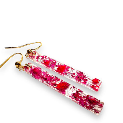 Pressed Flower Earrings with pink floral inclusions in clear resin. Long bar shape with gold ear wires for a modern look.