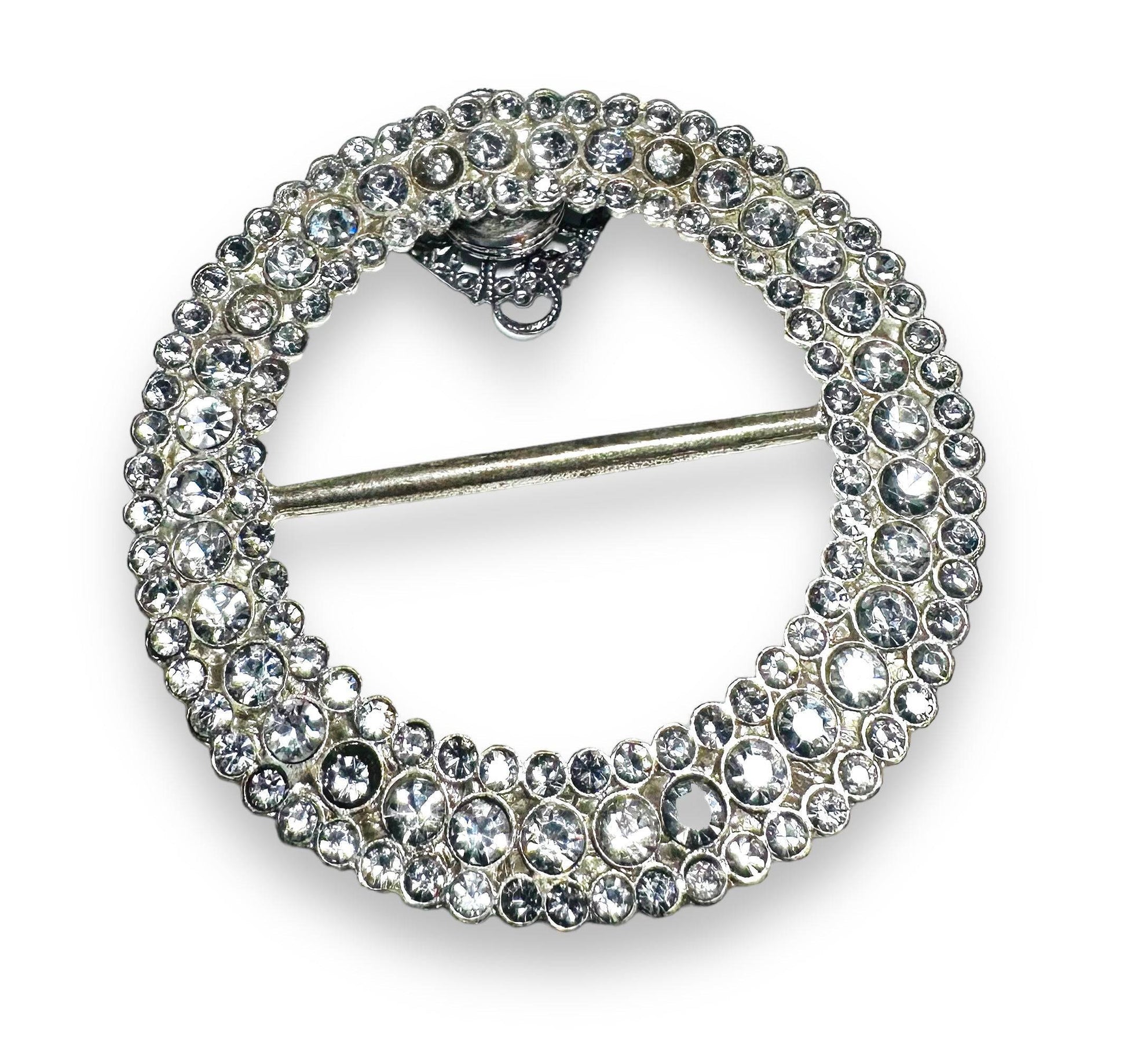Round rhinestone Uni-T magnet brooch with layered crystal design, offering strong magnetic hold for secure, stylish wear.