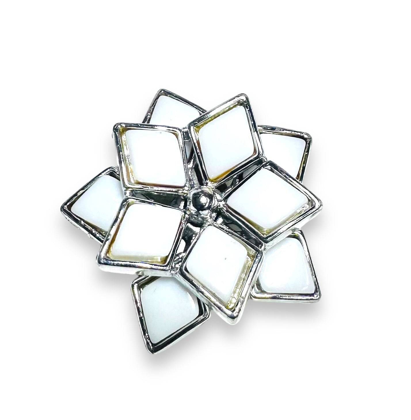 White enamel flower-shaped Uni-T magnet brooch with silver trim, a chic and modern accessory for scarves or lapels.