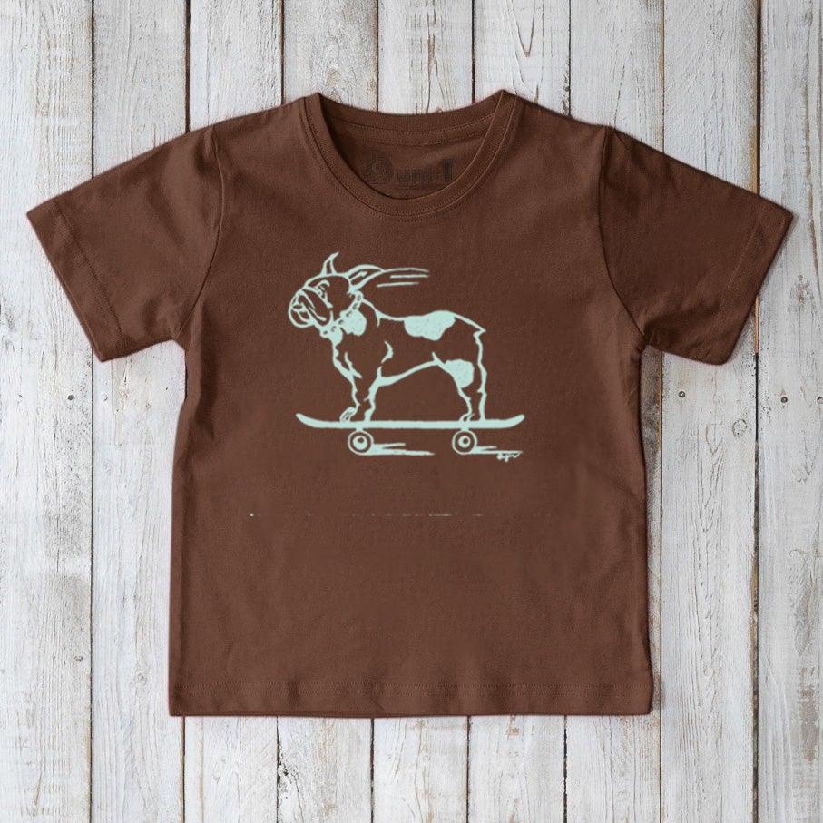 Brown organic cotton kids’ t-shirt with a mint green French Bulldog skateboarding graphic. Funny and eco-conscious Uni-T apparel.
