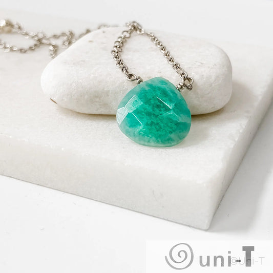 Buy Amazonite Gemstone Necklaces Online - Uni-T featuring a teardrop-shaped amazonite pendant on a sterling silver chain, displayed on white stone.